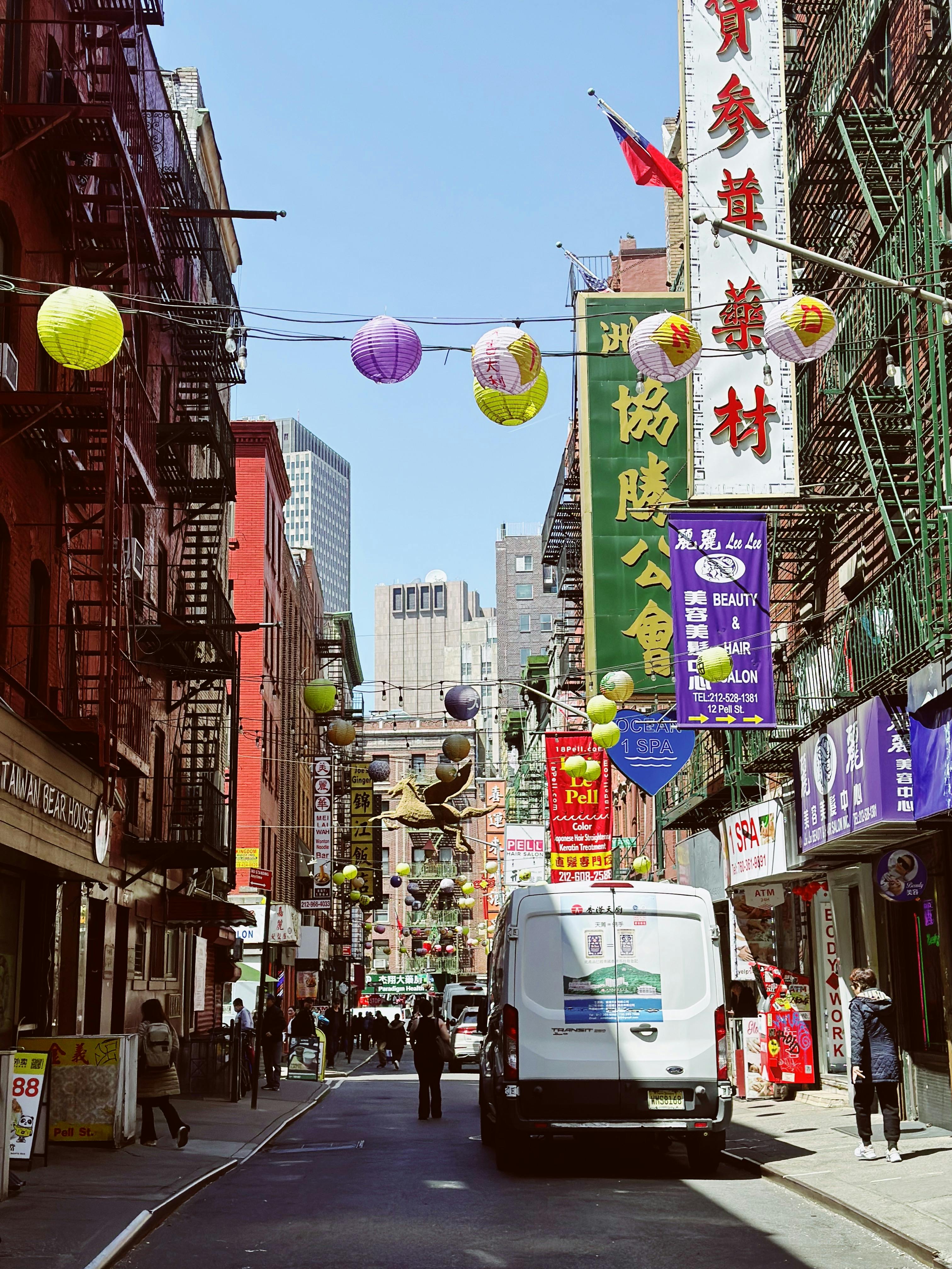 Colorful lanterns and signs line the bustling streets of New York City's iconic Chinatown.