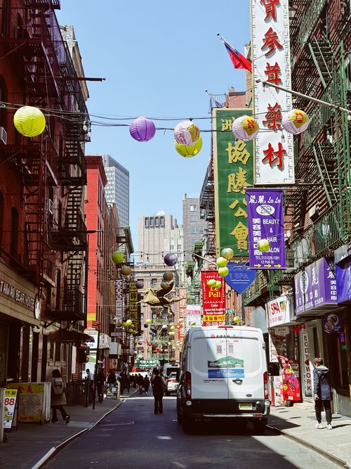 Free Colorful lanterns and signs line the bustling streets of New York City's iconic Chinatown. Stock Photo