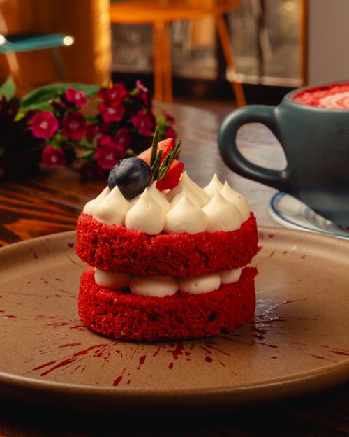 Free Delicious red velvet cake topped with berries on a wooden table, perfect for dessert lovers. Stock Photo