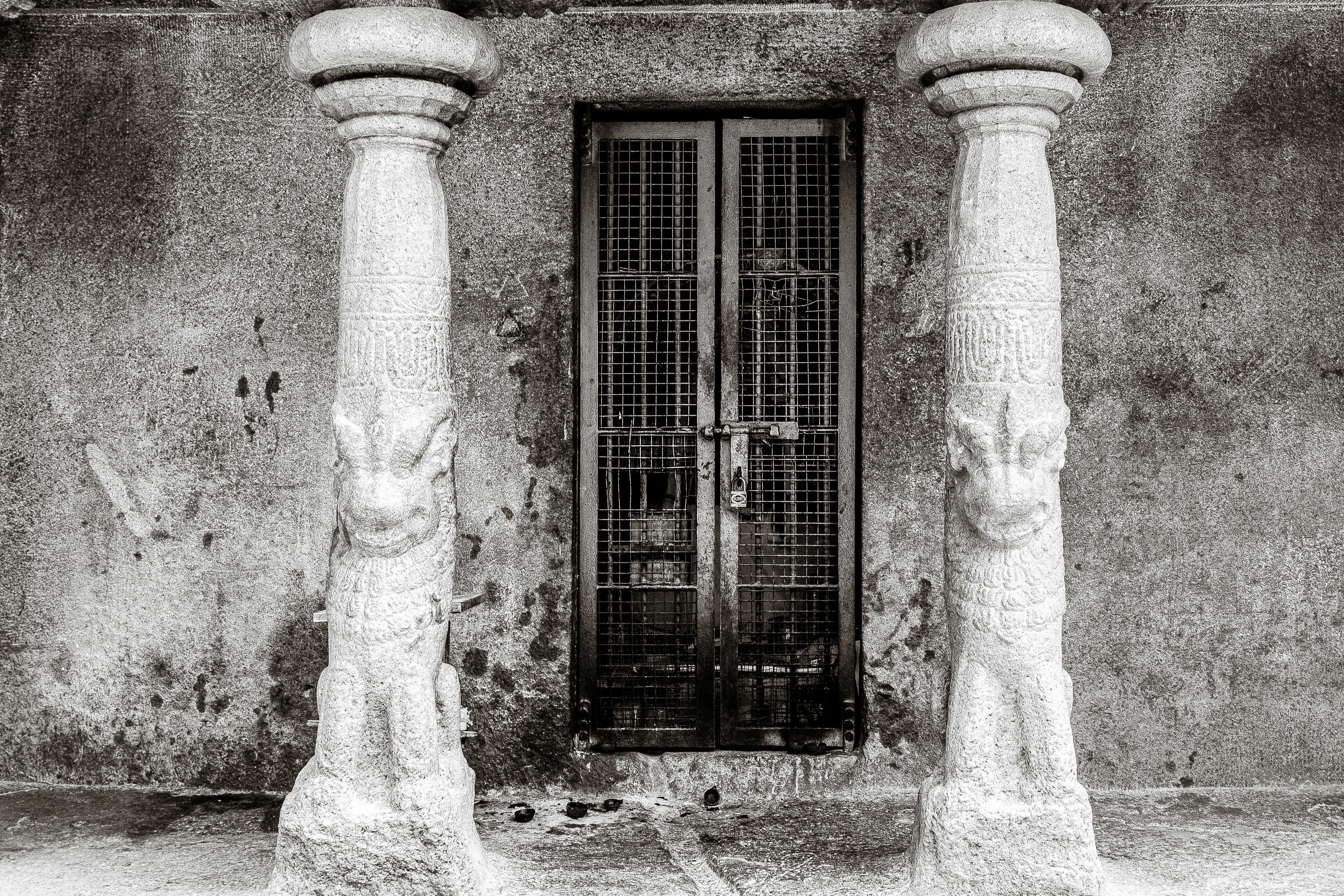 ancient stone pillars and gated doorway