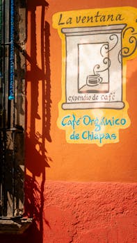 Vibrant cafe sign on an orange wall in San Miguel de Allende, México.
