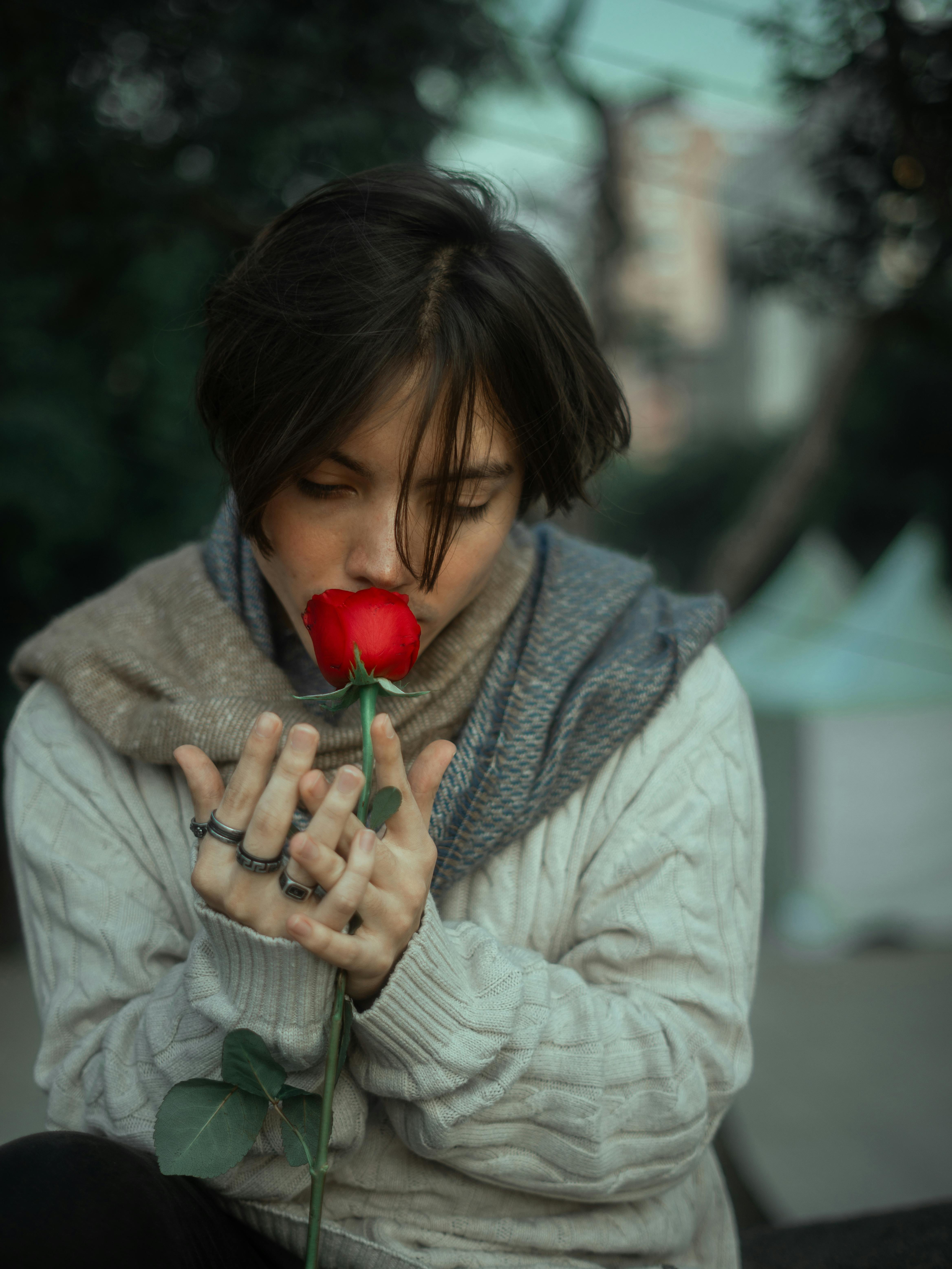 young adult with rose in urban setting