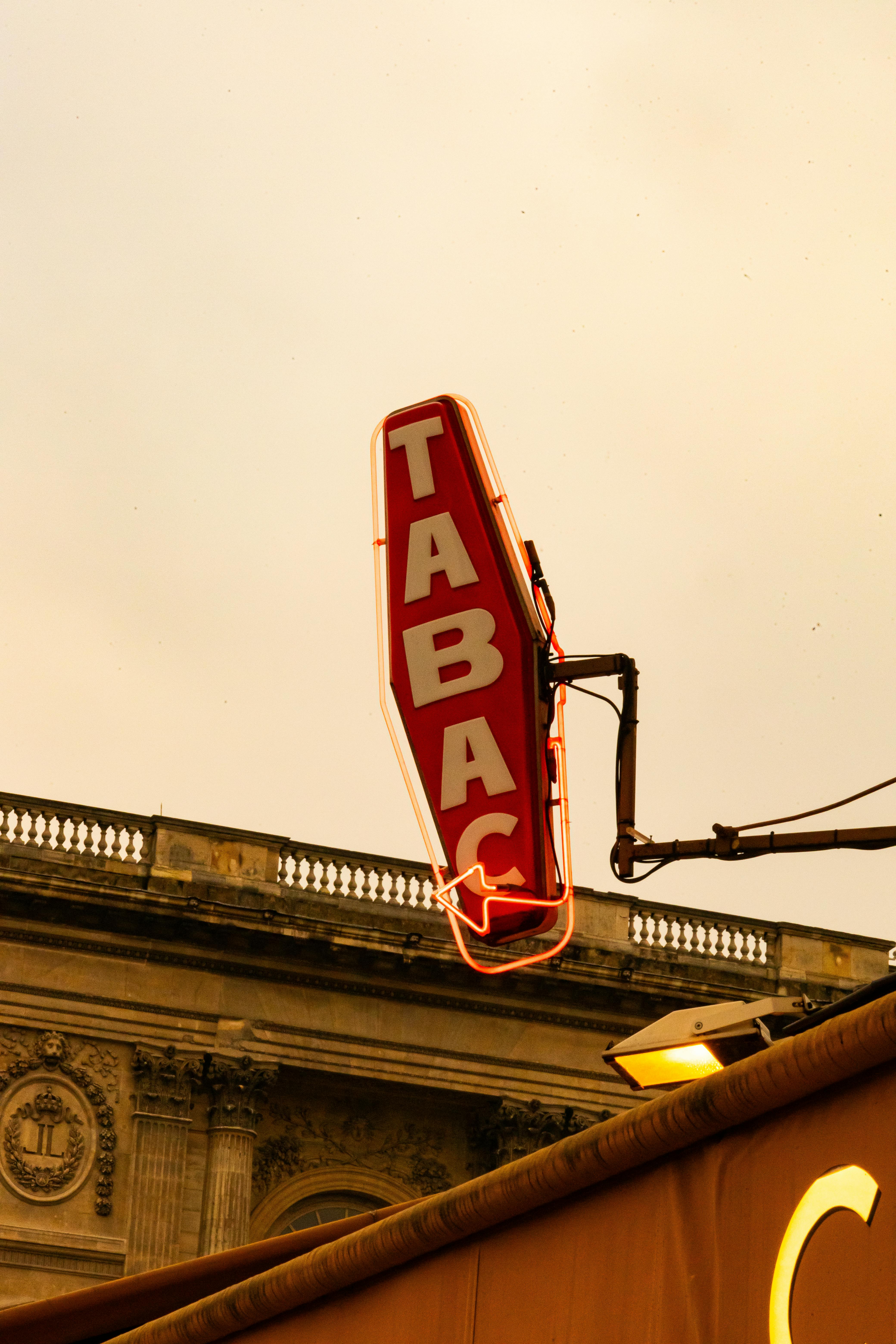 illuminated tabac sign in paris street scene