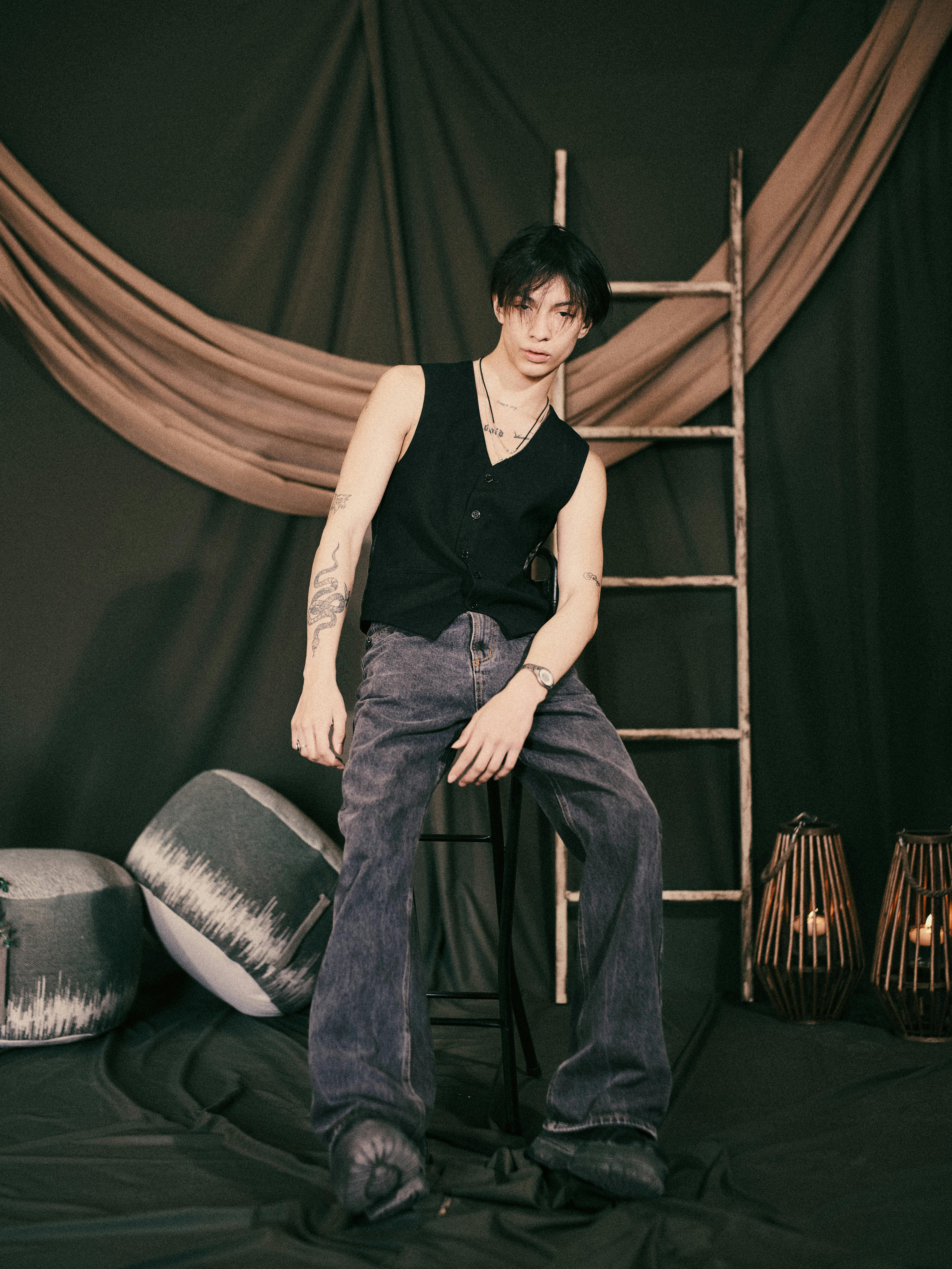 Stylish portrait of a young adult in a modern rustic setting.