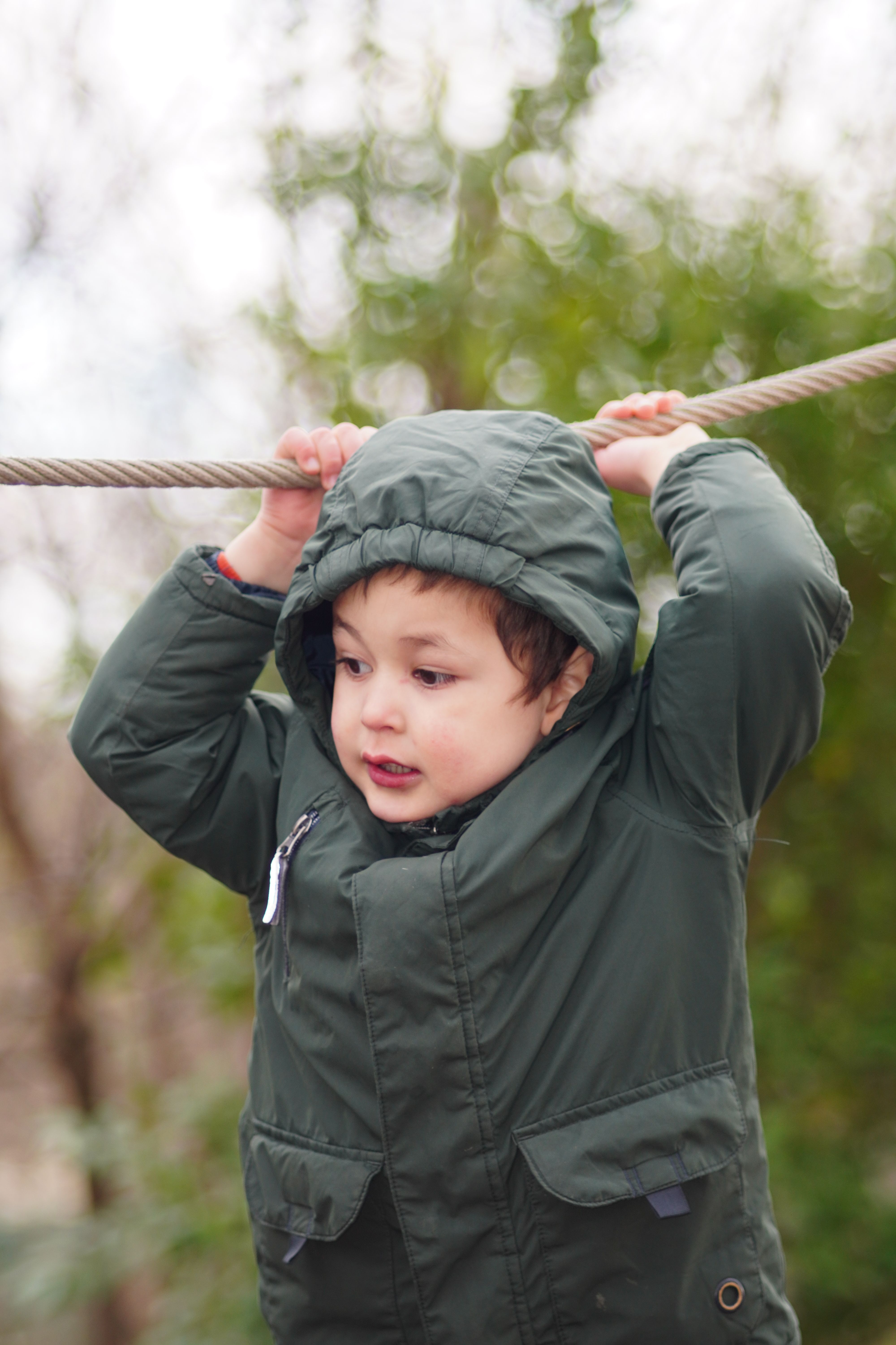 Child Enjoying Outdoor Playtime on Rope · Free Stock Photo