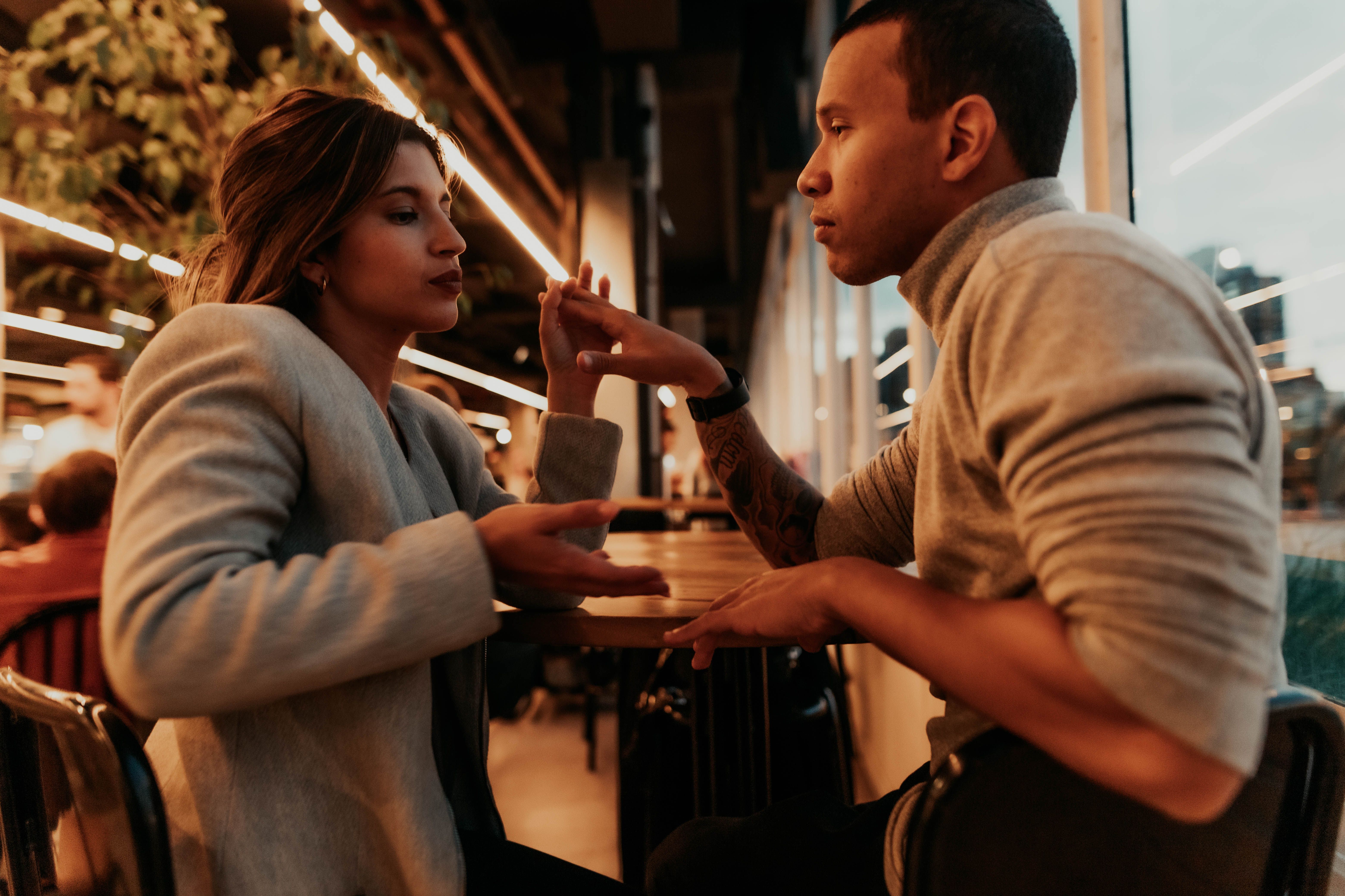 Romantic Couple Engaged in Conversation at Café · Free Stock Photo