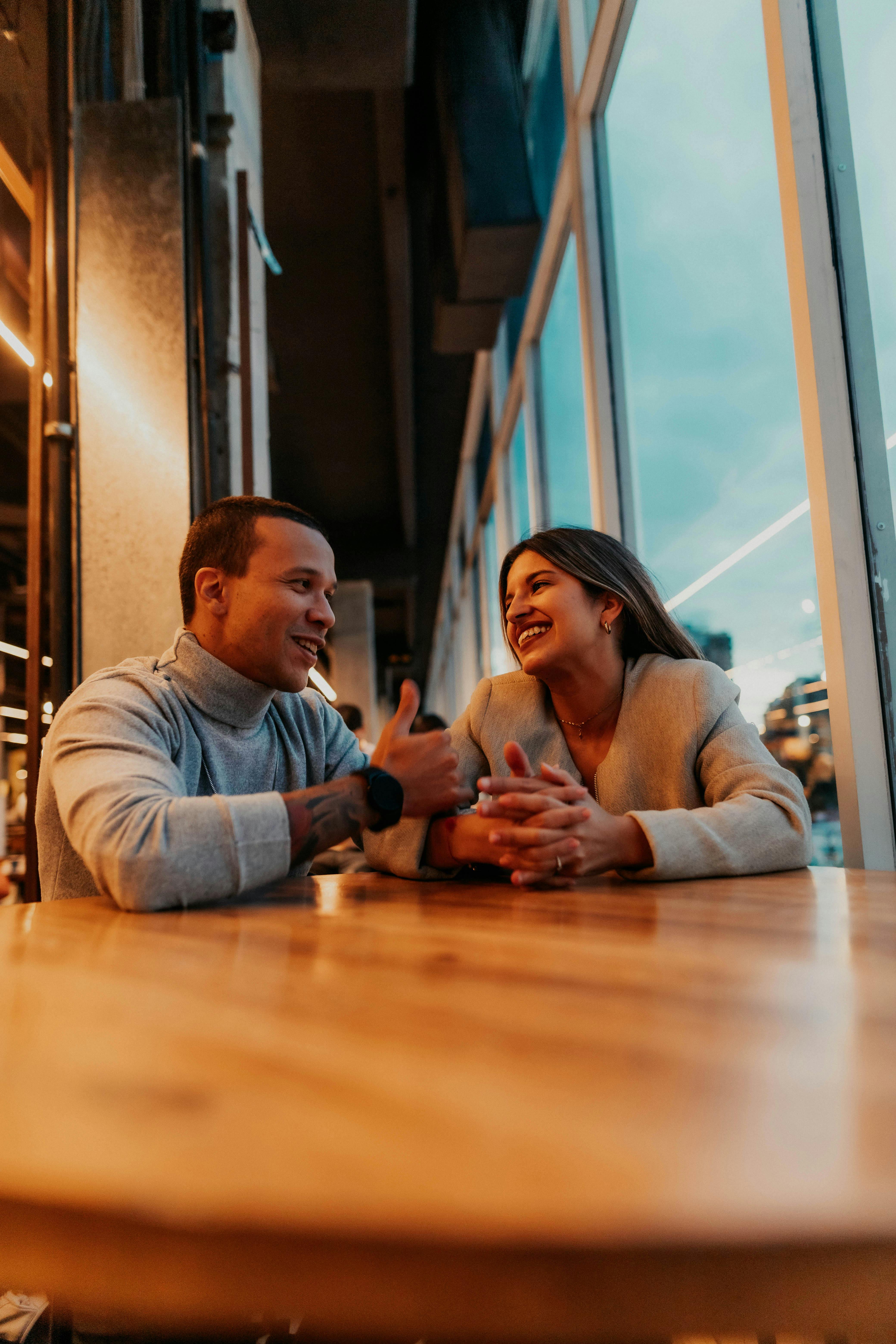 A couple enjoys a warm conversation at a café in Buenos Aires, creating a cozy and romantic atmosphere.