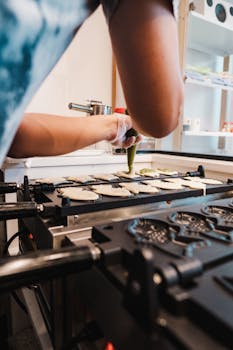 Close-up of making taiyaki in a Japanese street food market using a specialized pan.