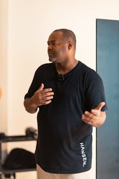 A mid adult man in casual attire engaging in a conversation indoors.