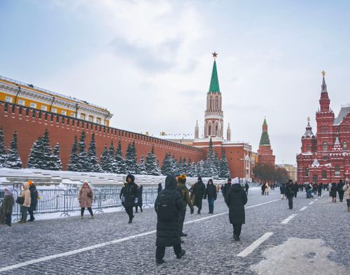 Free Snow-covered Red Square with St. Basil's Cathedral and people in winter gear. Stock Photo