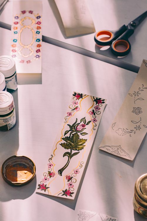 Free A flat lay shot of intricately designed bookmarks with art supplies on a table. Stock Photo