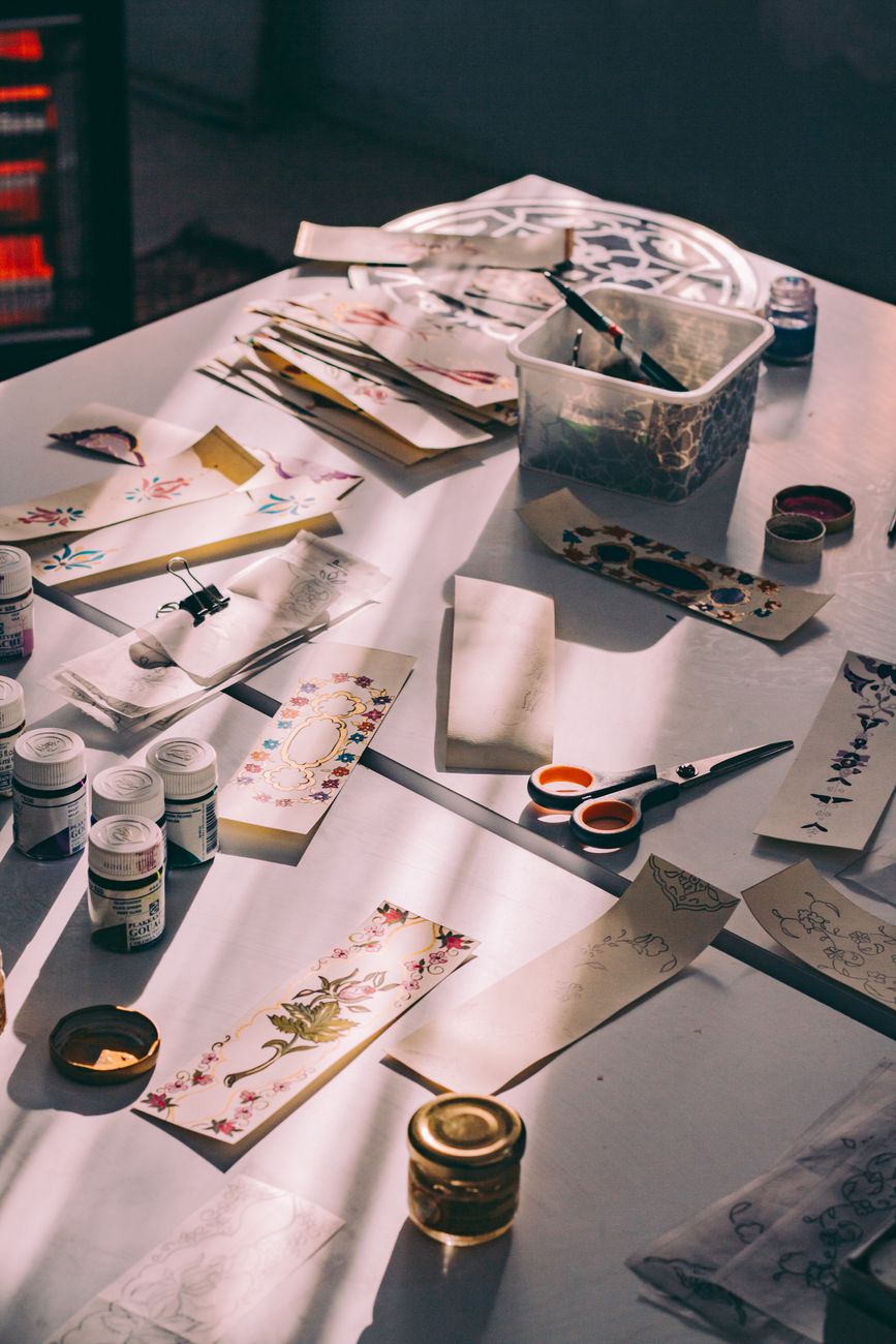 A collection of crafting materials and tools on a sunlit table, perfect for DIY projects.