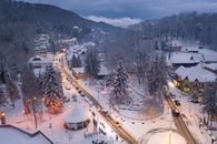 Aerial view of snowy Sovata, Romania village, illuminated at dusk.
