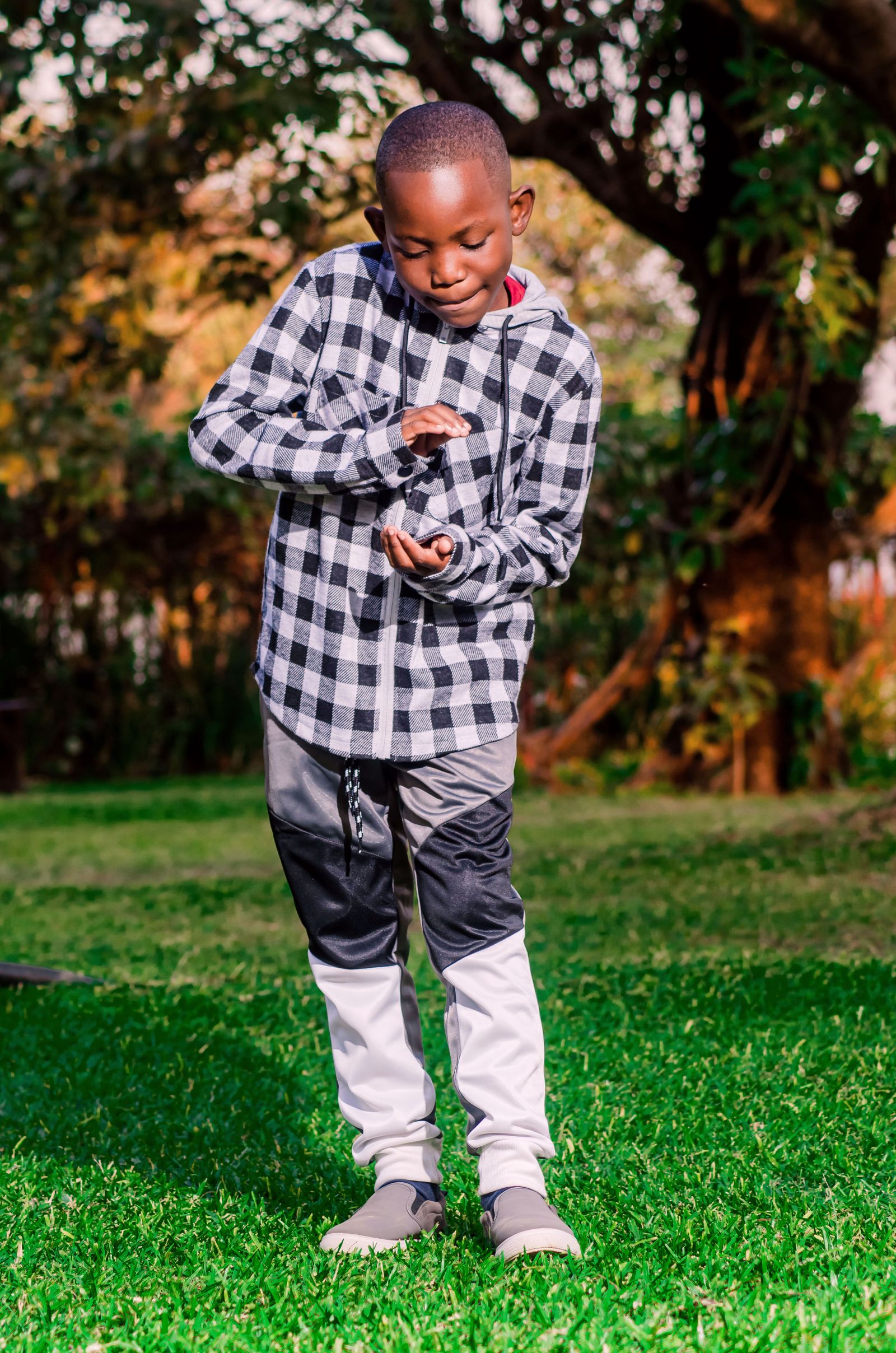 Boy in Checkered Suit Posing Outdoors · Free Stock Photo