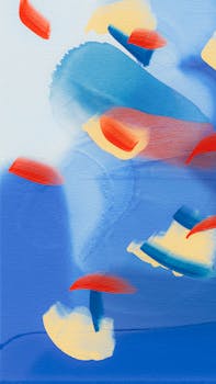 Vivid abstract artwork featuring bold splashes of red, blue, and yellow, creating a dynamic and expressive visual.