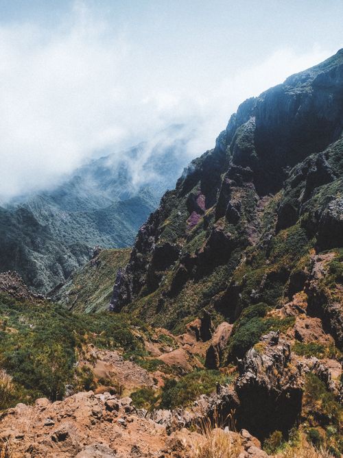 Free Stunning mountain scenery with dramatic clouds and rugged terrain. Stock Photo