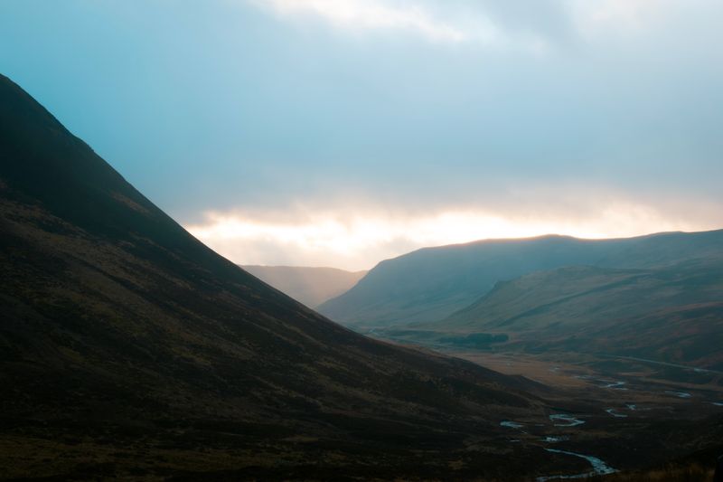 Dramatic Scottish Highland mountain valley with moody skies near Aberdeen
