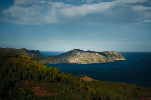 Free Vibrant view of Spanish coast showcasing lush green foliage and deep blue sea under clear skies. Stock Photo