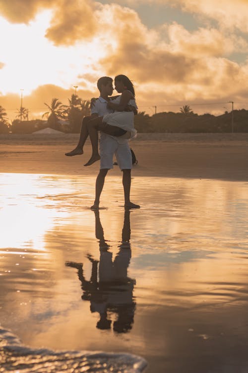 Free Man Carrying A Woman Stock Photo