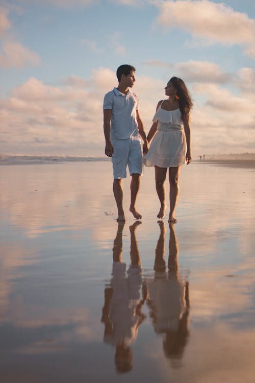 Free Couple Walking Along The Shore Stock Photo