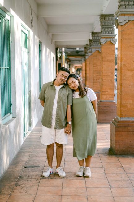 Happy couple in casual wear enjoying a warm day on a beautiful outdoor walkway.