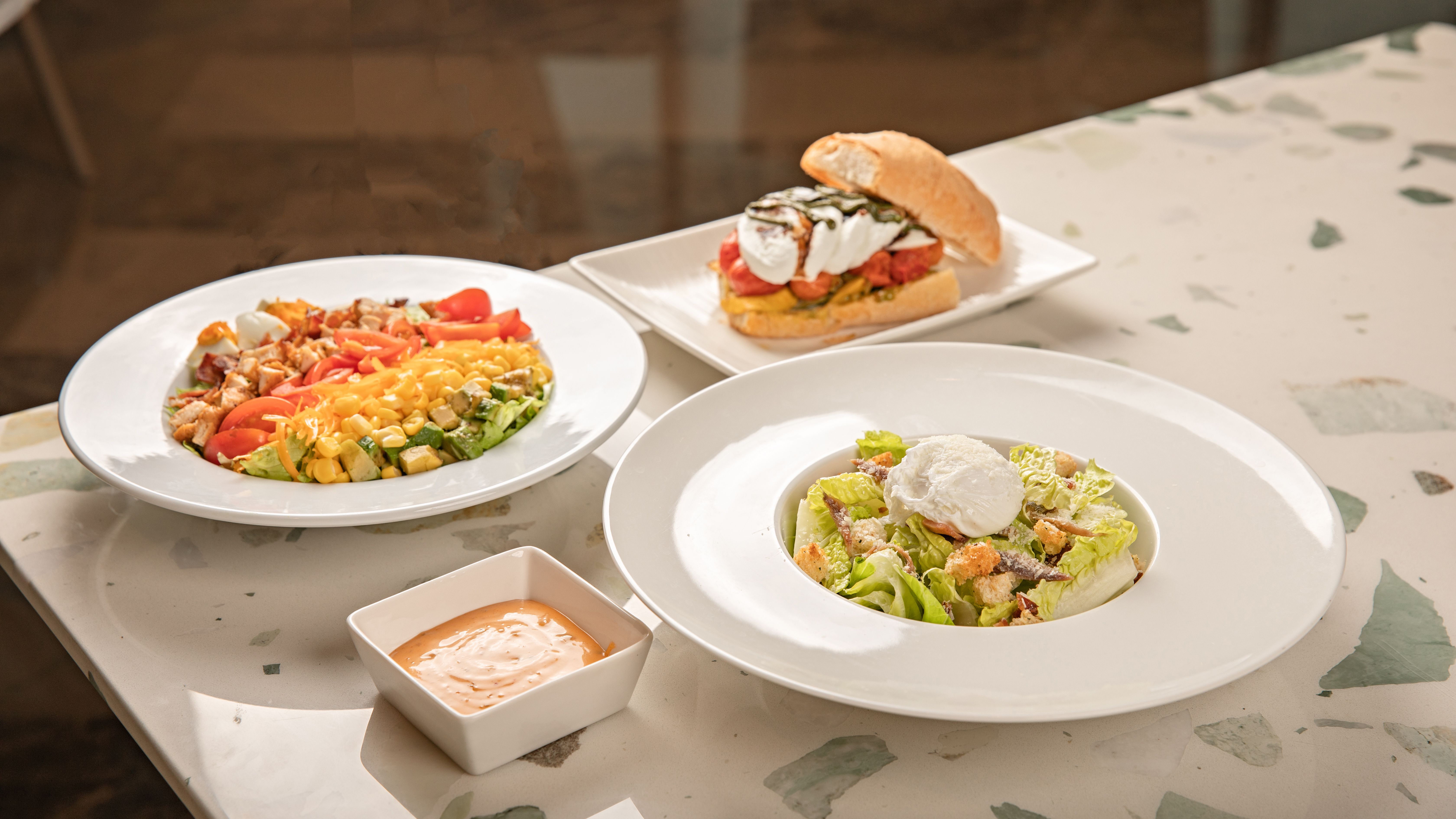 Cobb salad with blue cheese dressing served on a large platter
