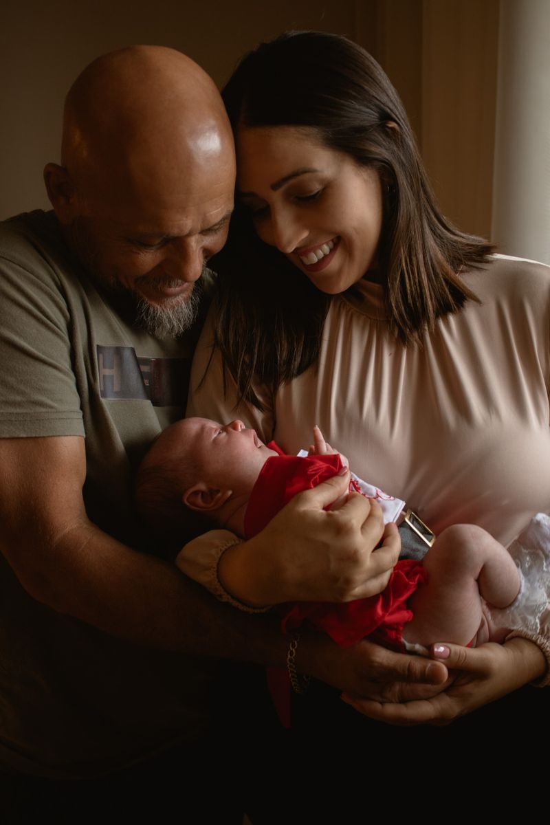 Parents embracing their newborn baby