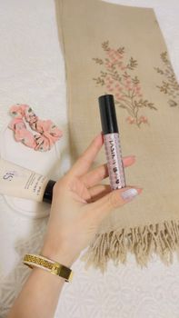 Minimalist display of makeup products with a floral theme, perfect for beauty blogs.