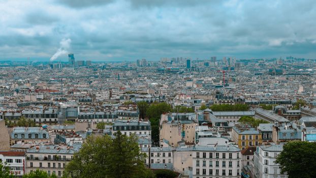 Stunning view of Paris skyline with historic rooftops on a cloudy day, seen from Montmartre.