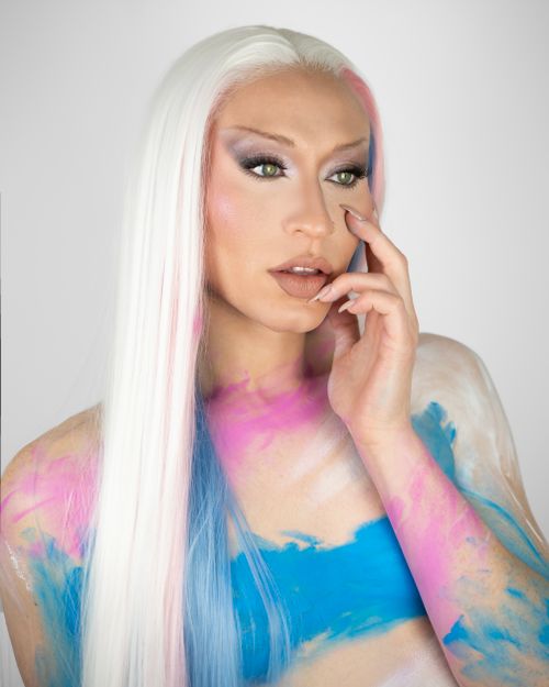 Free Creative portrait with colorful body paint and bold makeup artistry. Stock Photo