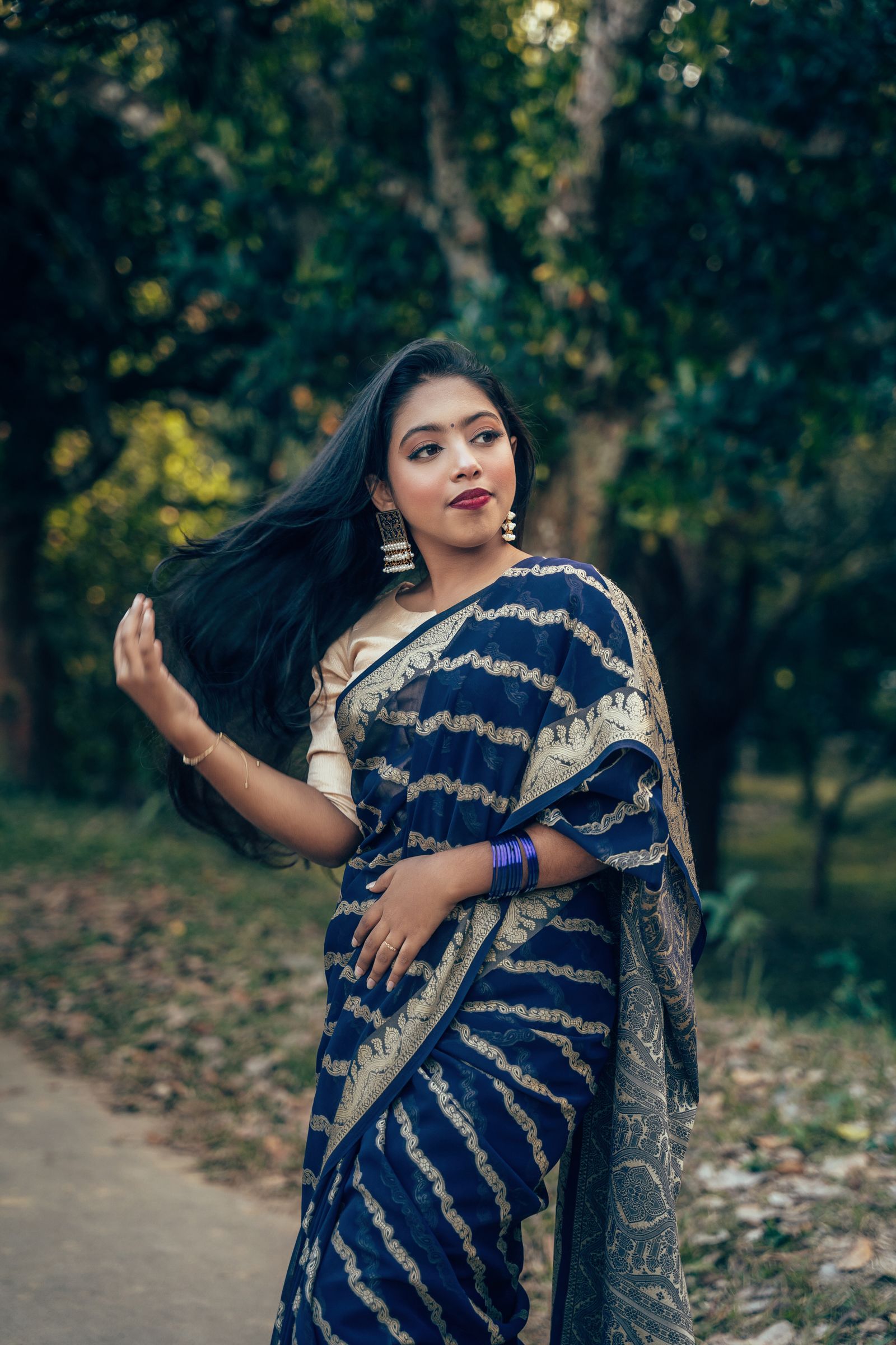 Elegant Woman in Traditional Bengali Saree Outdoors · Free Stock Photo