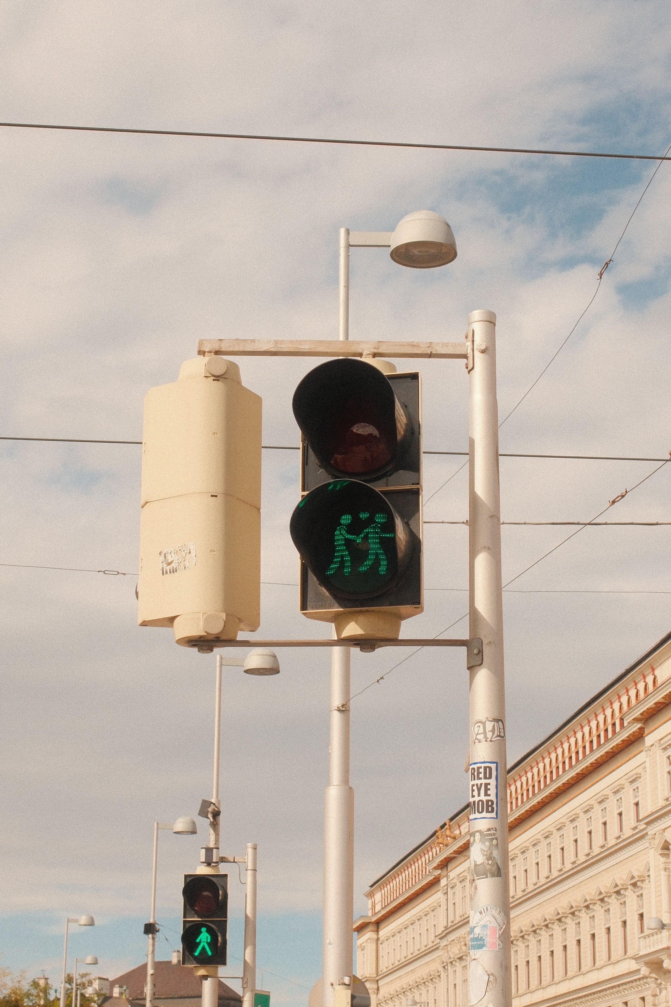 Urban Street Traffic Light Against Cloudy Sky · Free Stock Photo