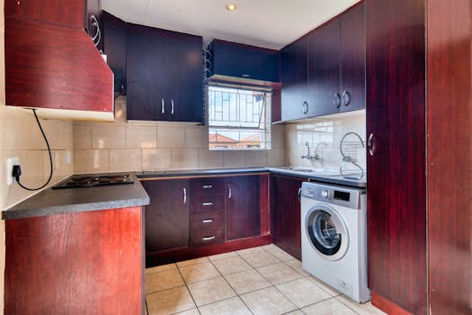Stylish kitchen featuring wooden cabinets, modern appliances, and tiled flooring.