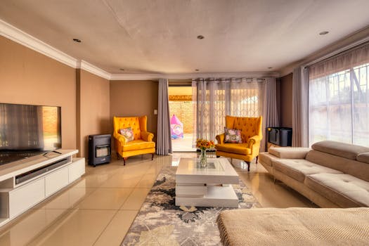 Stylish living room interior featuring vibrant yellow chairs and cozy design elements.