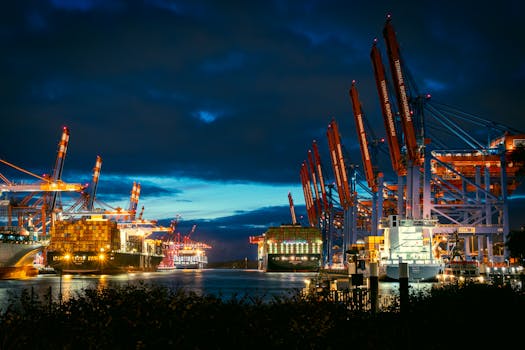 Illuminated cargo port with cranes and ships at night. Maritime industry scene.