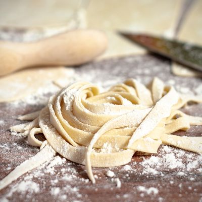Fresh pasta dusted with flour on a wooden board — photo by Katja B on Pexels