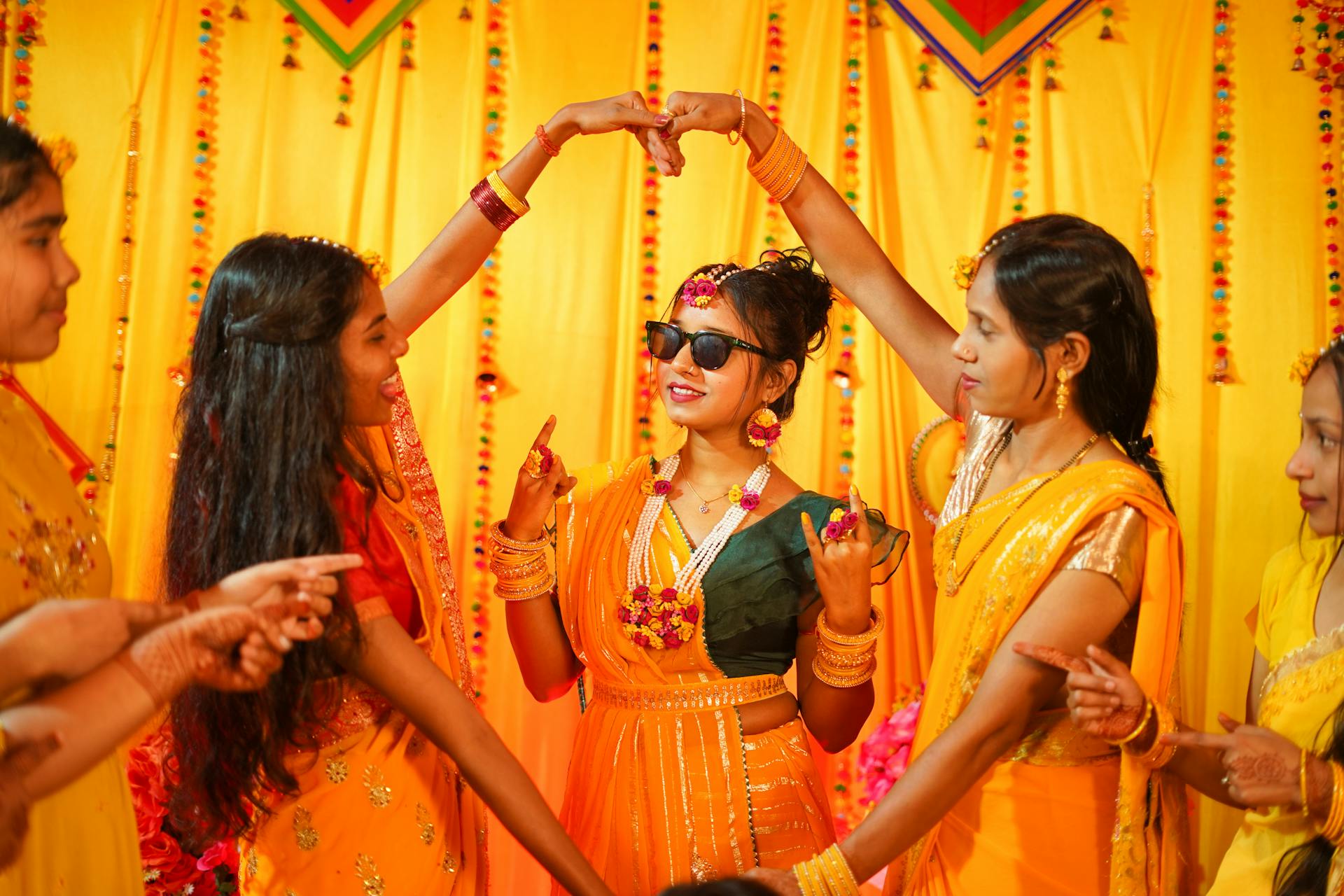 Haldi ceremony traditional Indian bride in group photo.