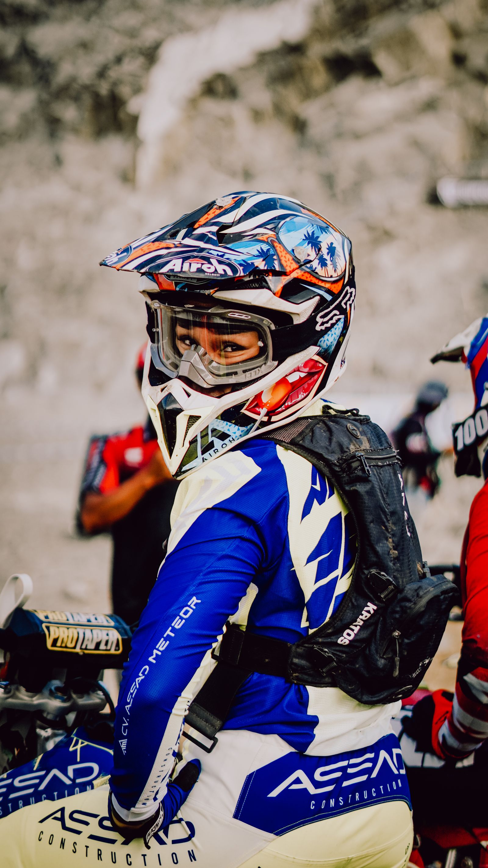 Motocross rider in full gear on a dirt bike, matching MX knee brace selection. Photo: Pexels.