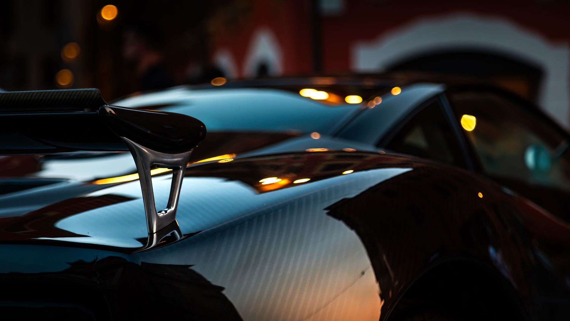 Close-up of a hypercar with carbon fiber details and elegant reflections at dusk.