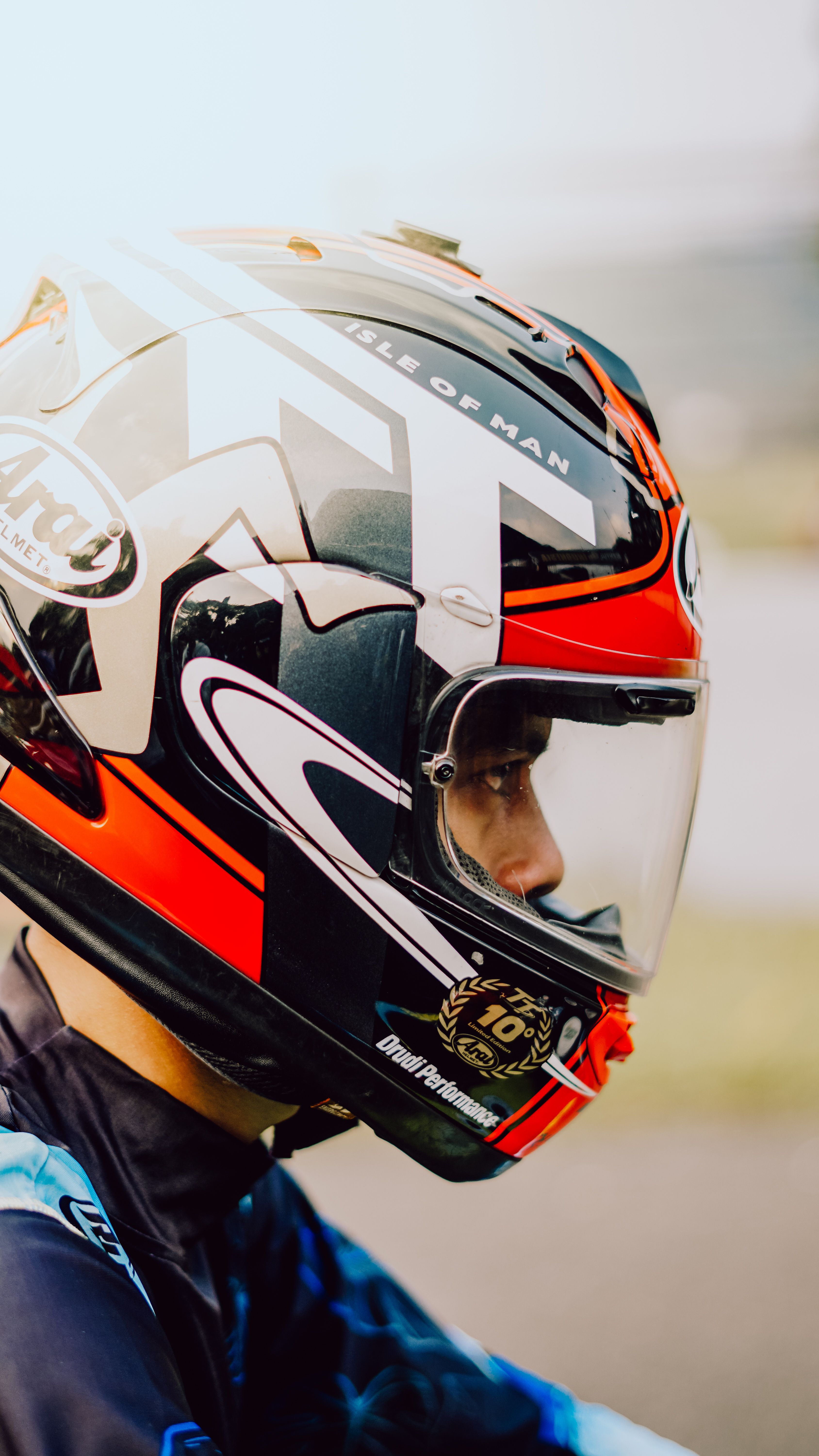 A focused motorcycle rider in full gear during a race in Jakarta, Indonesia.