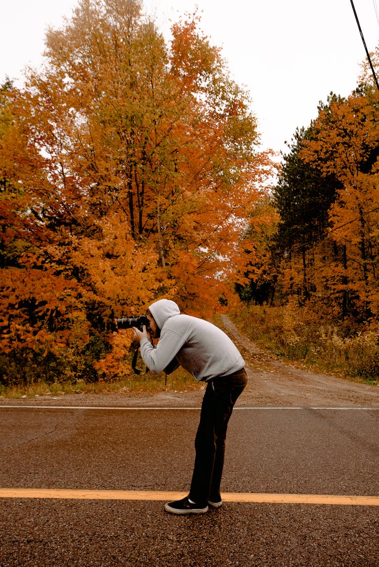 Person Taking Photo In The Middle Of The Road