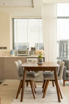 Contemporary kitchen and dining space with modern appliances and stylish furniture.