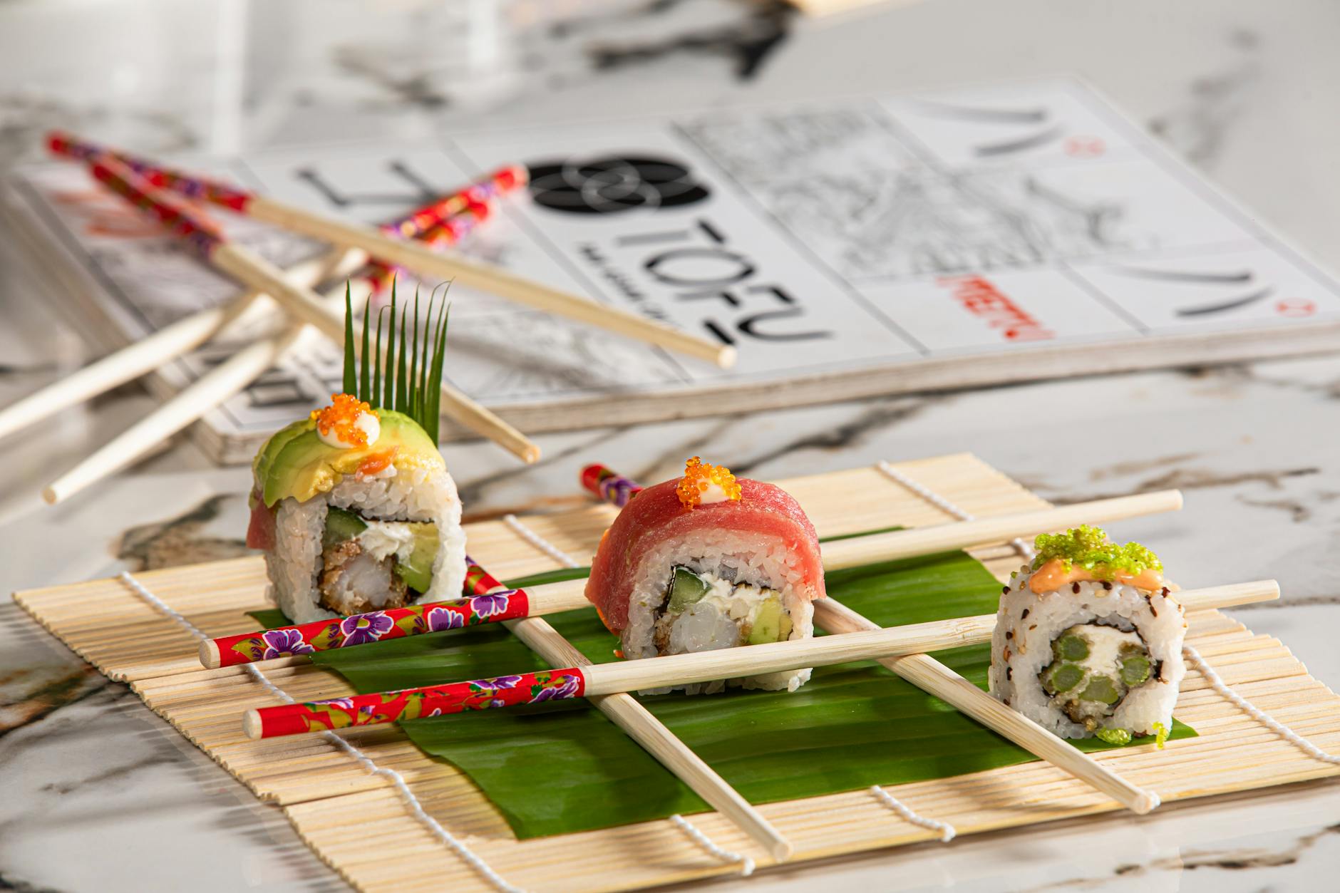 https://www.pexels.com/photo/sushi-rolls-with-chopsticks-on-bamboo-plate-30708194/