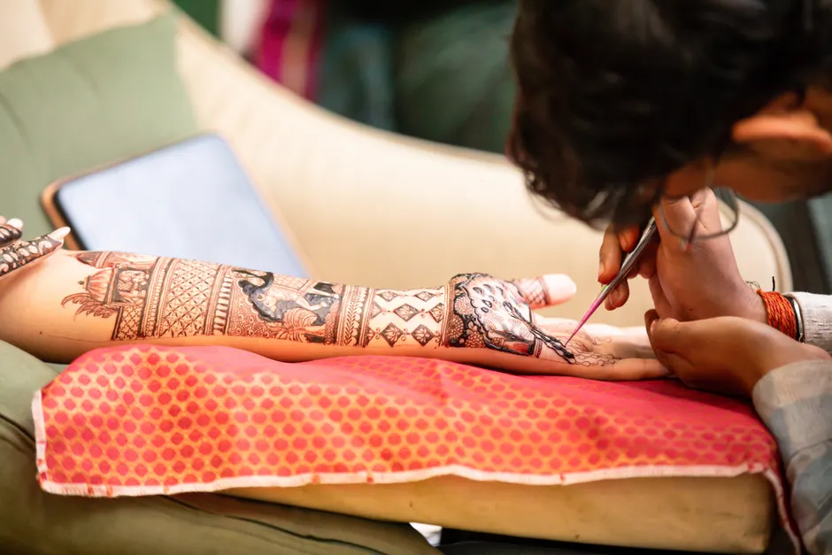 Step-by-step process of applying a water transfer tattoo to wrist with water