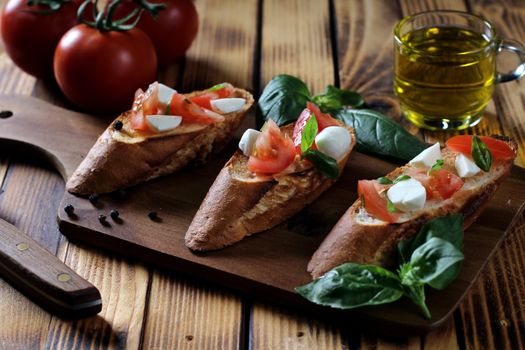 Savor fresh bruschetta topped with tomatoes, mozzarella, and basil on rustic bread.