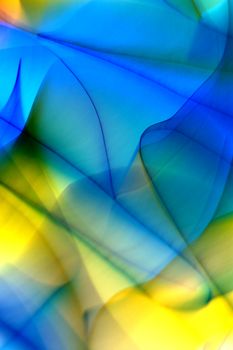 Colorful abstract art featuring flowing blue and yellow wave-like patterns.