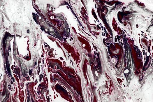 Vivid abstract fluid art featuring red and white swirling patterns creating a dynamic visual texture.