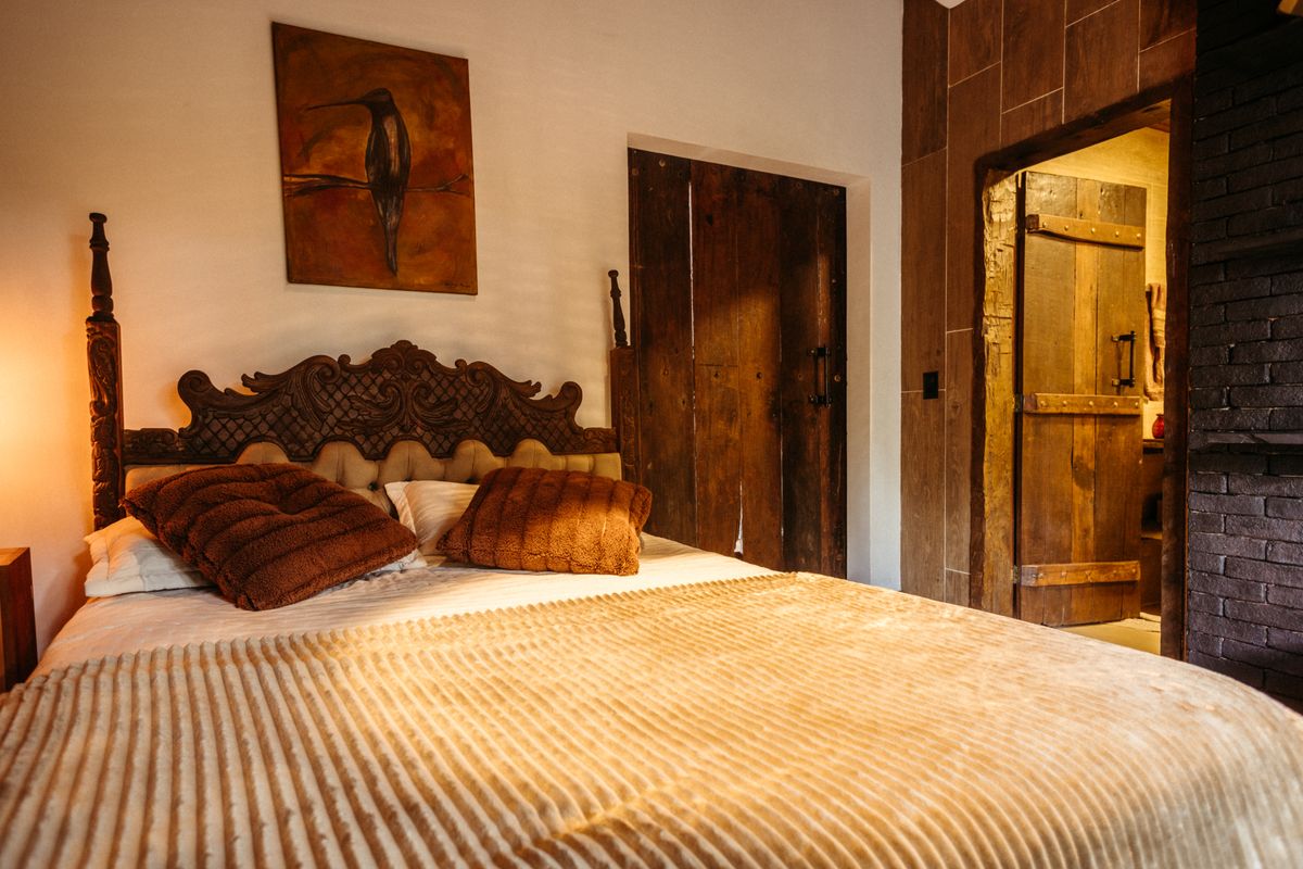 Room with a carved wooden headboard and warm light