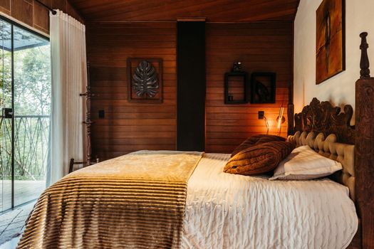 A rustic wooden bedroom with cozy decor in Santa Teresa, Brazil.