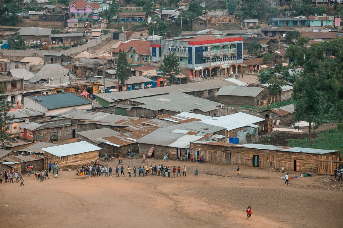 Free Aerial view of a lively community scene in an African town with colorful buildings. Stock Photo